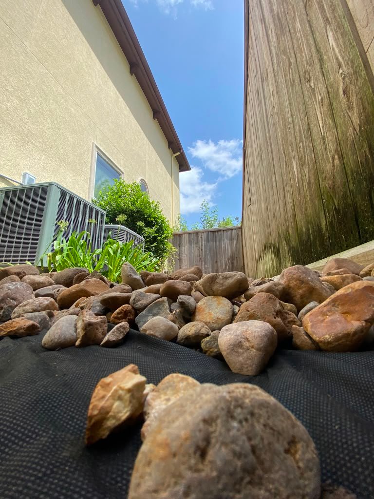 Decorative rock landscape detail completed by Rainlandscaping